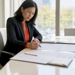 Woman reviewing legal translation checklist at desk