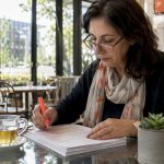 NAATI translator reviewing official documents at desk