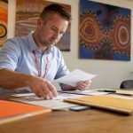 Immigration officer reviewing translated visa documents