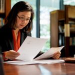 Woman reviewing visa document translation side by side