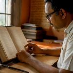 Open Tamil language dictionary and calligraphy brush