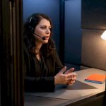 Certified interpreter working inside an interpreting booth